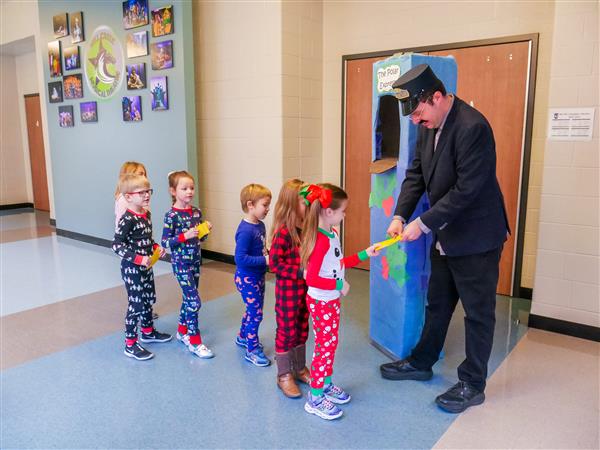 Students in holiday clothes doing festive things at school. 